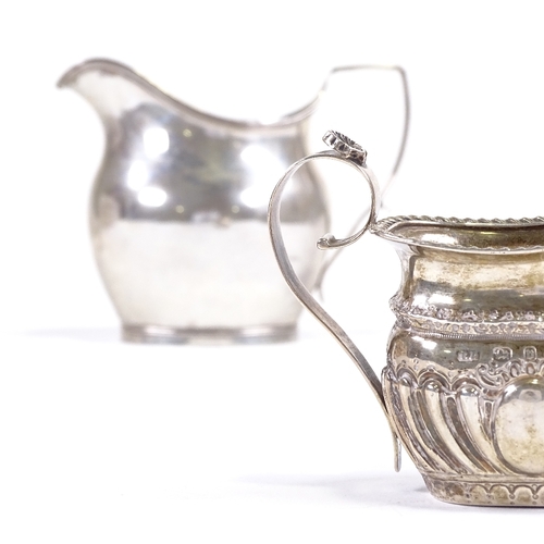 703 - A small Victorian silver cream jug, hallmarks Birmingham 1895, and an Art Deco helmet-shaped cream j... 