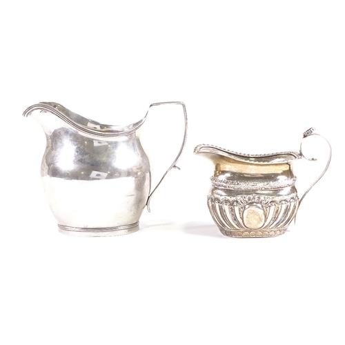 703 - A small Victorian silver cream jug, hallmarks Birmingham 1895, and an Art Deco helmet-shaped cream j... 