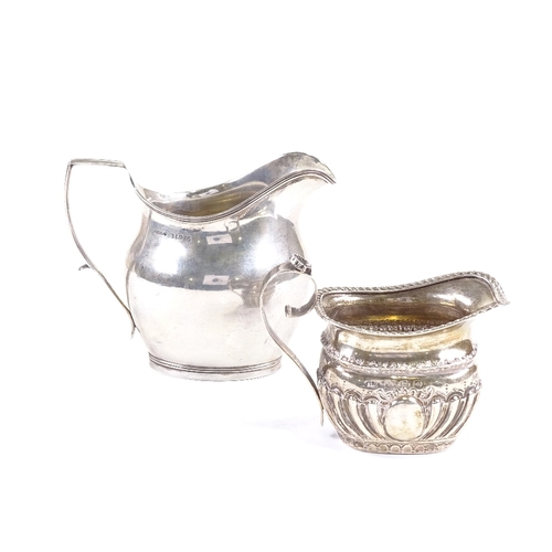 703 - A small Victorian silver cream jug, hallmarks Birmingham 1895, and an Art Deco helmet-shaped cream j... 