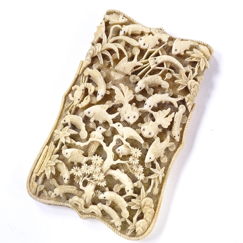 100 - A 19th century Chinese high relief carved ivory card case, the front depicting exotic birds and fish... 