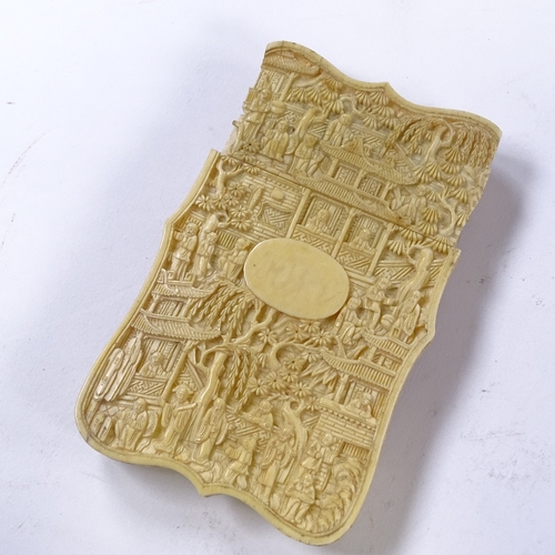 100 - A 19th century Chinese high relief carved ivory card case, the front depicting exotic birds and fish... 