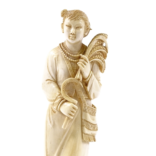 102 - A Chinese carved ivory figure, girl holding a sickle and wheatsheaves, early 20th century, height 17... 