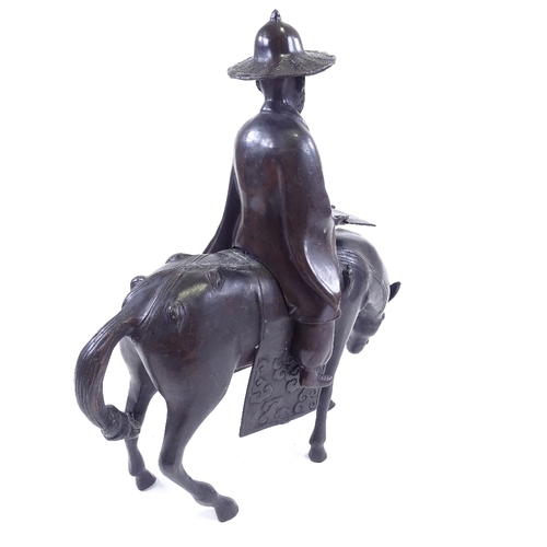 112 - A patinated bronze Chinese sculpture in the form of a sage on horseback, height 42cm, probably mid-2... 