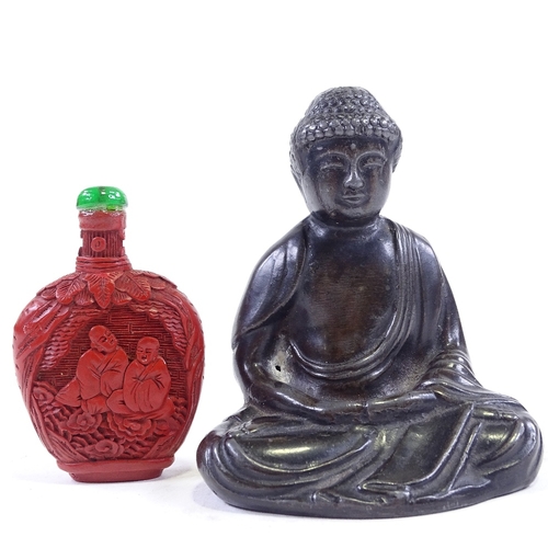 127 - A Chinese patinated spelter seated Buddha, height 10cm, a carved cinnabar snuff bottle, and a carved... 