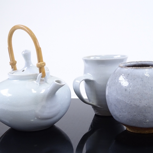 192 - A pale blue glaze Studio porcelain teapot and matching mug, by Mary Rich, and a glazed Studio potter... 