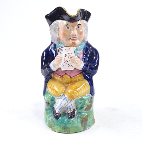 195 - An Antique Staffordshire animal, height 9cm, and a Staffordshire Toby jug (2)