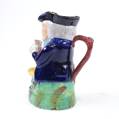 195 - An Antique Staffordshire animal, height 9cm, and a Staffordshire Toby jug (2)