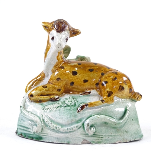 195 - An Antique Staffordshire animal, height 9cm, and a Staffordshire Toby jug (2)