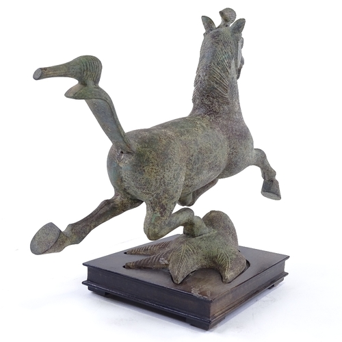 48 - A Chinese verdigris bronze galloping horse, after the Antique, on wooden stand, height 30cm, length ... 
