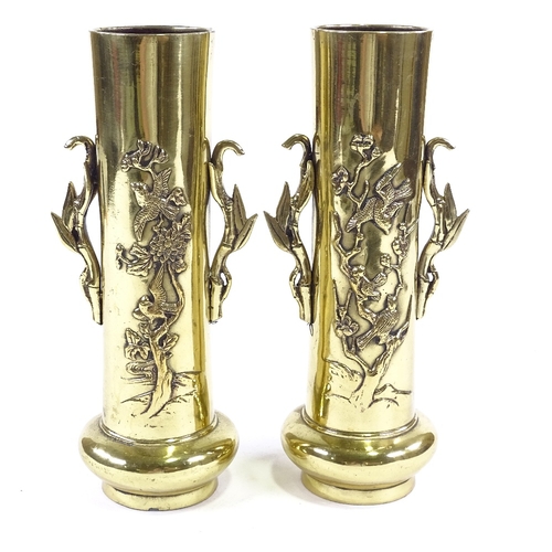 55 - A pair of Chinese polished bronze sleeve vases, with relief decoration and cast handles, height 26cm... 