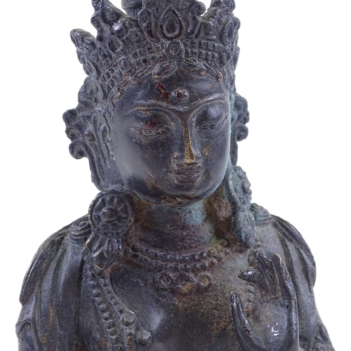 64 - An Oriental bronze seated deity, height 25cm