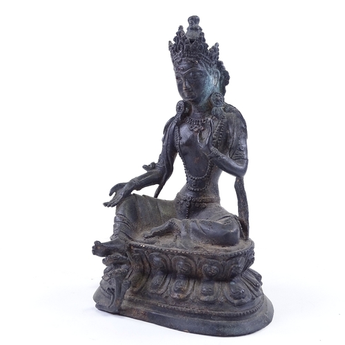 64 - An Oriental bronze seated deity, height 25cm