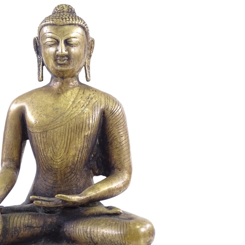 68 - An Oriental polished bronze seated Buddha, height 37cm