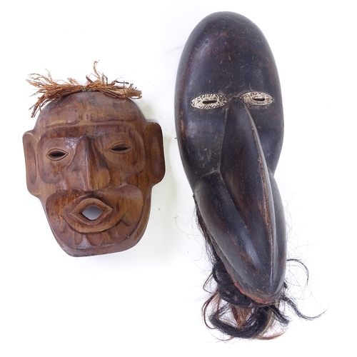 74 - A Dan Tribal stained wood bird mask, height 40cm, and a Native American carved wood mask (2)