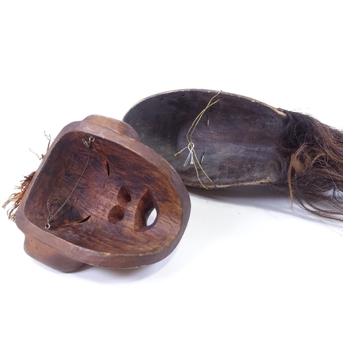 74 - A Dan Tribal stained wood bird mask, height 40cm, and a Native American carved wood mask (2)