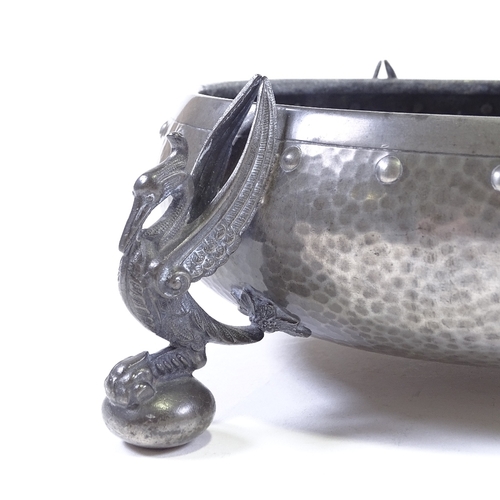 82 - An Arts and Crafts planished pewter fruit bowl, on cast phoenix design feet, stamped Homeland, seria... 