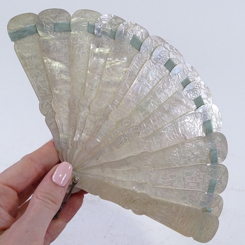 98 - A Chinese 19th century relief carved mother-of-pearl fan, carved on both sides, length 13.5cm, and a... 