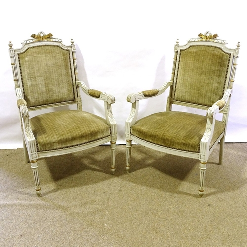 204 - A pair of French carved painted and gilded wood-framed open arm salon chairs