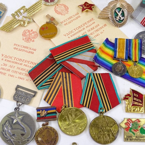 156 - A collection of Russian medals and badges, including military and public service awards