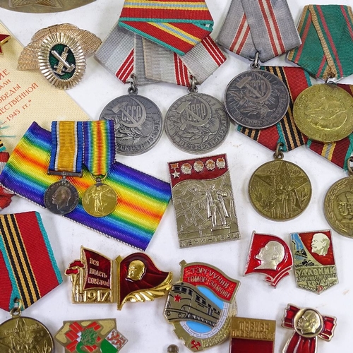 156 - A collection of Russian medals and badges, including military and public service awards