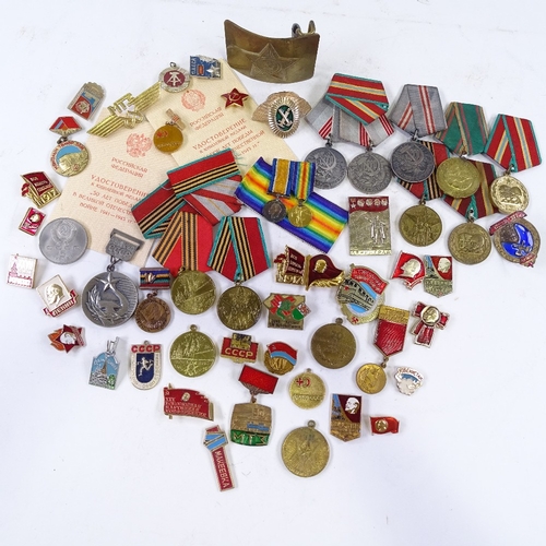 156 - A collection of Russian medals and badges, including military and public service awards