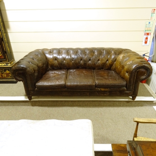 209 - A brown buttoned leather-upholstered 3-seater Club Chesterfield sofa, early 20th century, overall le... 