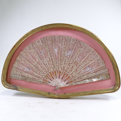 210 - A hand painted lace fan, with carved mother of pearl and ivory sticks, in frame, frame width 76cm.