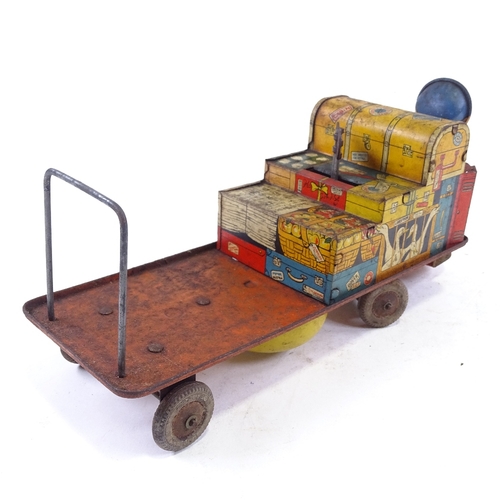 221 - A mid-20th century tinplate clockwork railway luggage trolley and driver, length 30cm