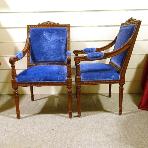 235 - A pair of Continental carved and stained wood framed open-arm chairs, with blue velvet upholstery