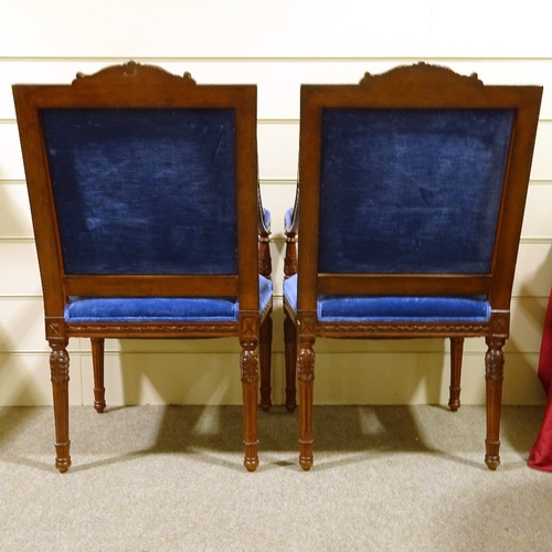 235 - A pair of Continental carved and stained wood framed open-arm chairs, with blue velvet upholstery