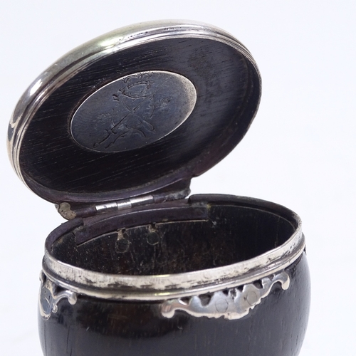 247 - An 18th century unmarked silver-mounted horn snuff mull, with hinged lid and armorial panel to the u... 