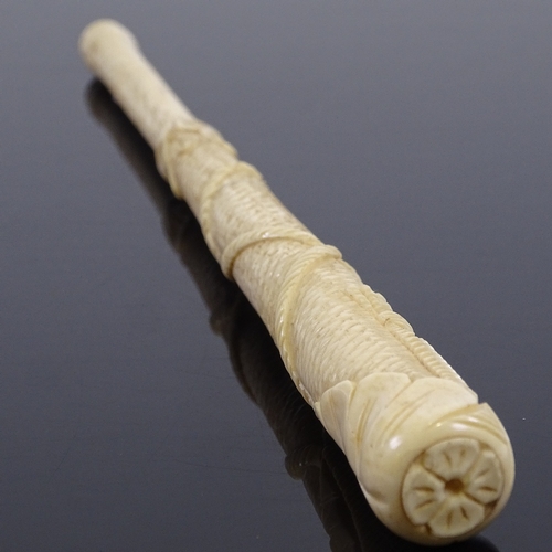 249 - A 19th century relief carved bone parasol handle, with tassel and rope decoration, length 24cm