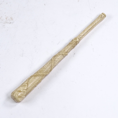 249 - A 19th century relief carved bone parasol handle, with tassel and rope decoration, length 24cm