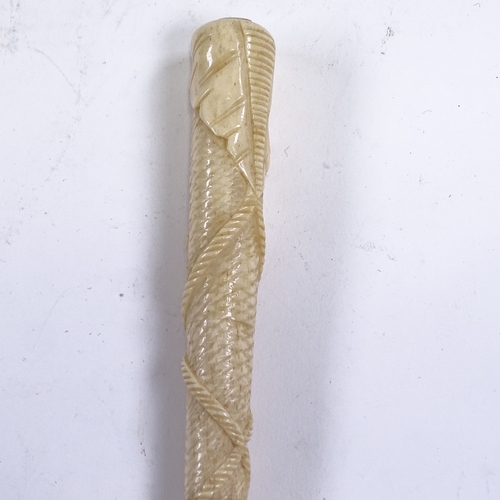 249 - A 19th century relief carved bone parasol handle, with tassel and rope decoration, length 24cm