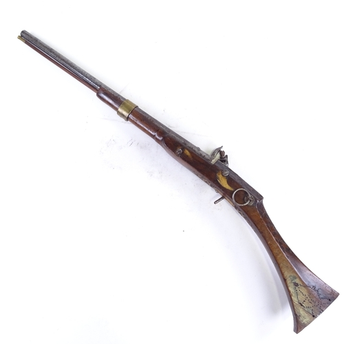 298 - An 18th century Middle Eastern flintlock rifle, with carved walnut stock and carved horn trigger pla... 