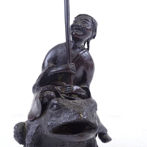 303 - A Chinese patinated bronze sculpture of a man riding a toad, height to man's head 16cm