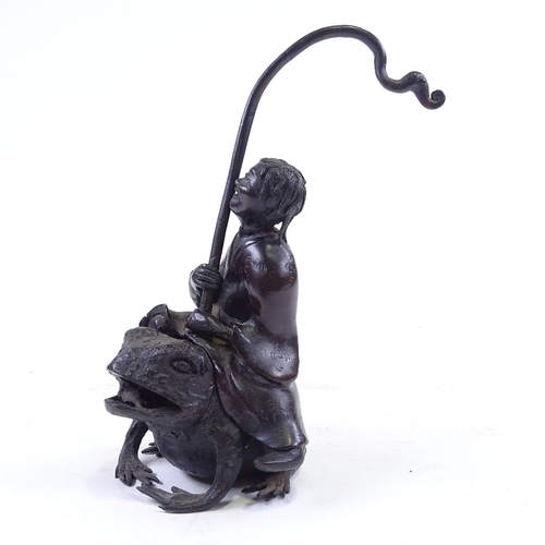 303 - A Chinese patinated bronze sculpture of a man riding a toad, height to man's head 16cm