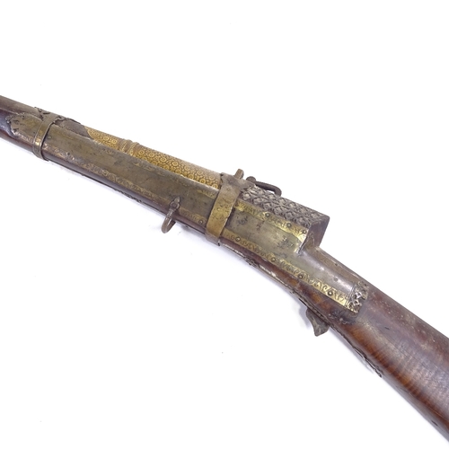 332 - An 18th century Indian or Middle Eastern matchlock rifle, gold inlaid muzzle and floral gold and sil... 