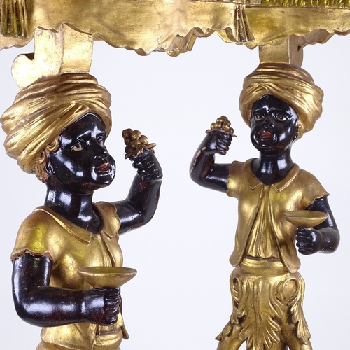 217 - A pair of ornate carved painted and gilded wood, Blackamoor figure pedestals on carved giltwood trip... 