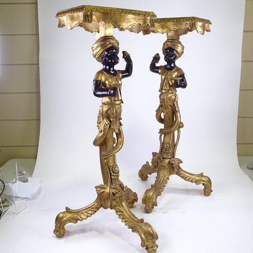 217 - A pair of ornate carved painted and gilded wood, Blackamoor figure pedestals on carved giltwood trip... 