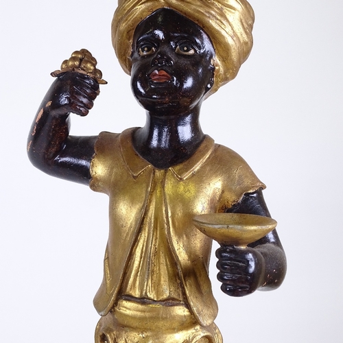 217 - A pair of ornate carved painted and gilded wood, Blackamoor figure pedestals on carved giltwood trip... 