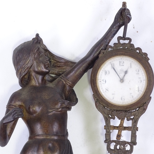 328 - A 19th century French patinated spelter Mystery clock, supported by a Classical figure