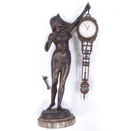 328 - A 19th century French patinated spelter Mystery clock, supported by a Classical figure