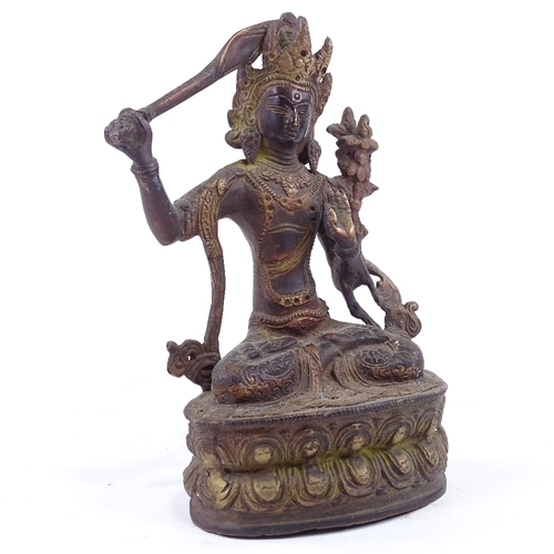 62 - An Eastern polished bronze seated deity, height 28cm