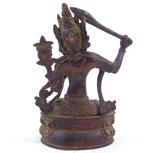 62 - An Eastern polished bronze seated deity, height 28cm