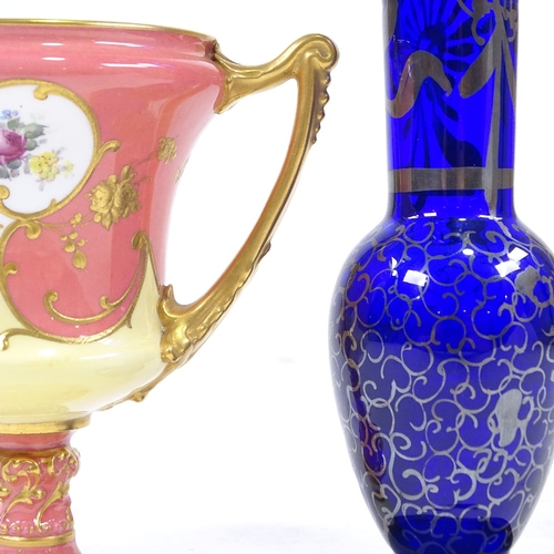 88 - A Royal Crown Derby gilded urn with hand painted decoration, height 13cm, and a tall blue glass vase... 