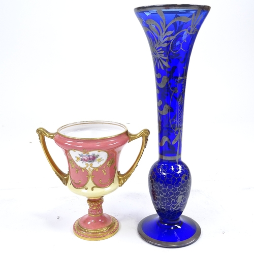 88 - A Royal Crown Derby gilded urn with hand painted decoration, height 13cm, and a tall blue glass vase... 