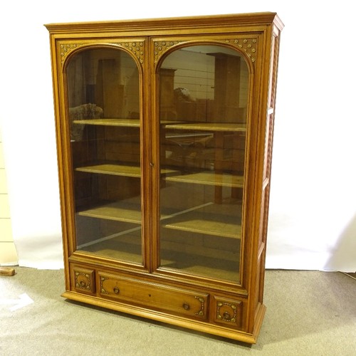 324 - A French cherrywood 2-door bookcase, circa 1920s, arch glazed panelled doors with floral carved gild... 