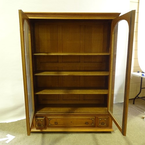 324 - A French cherrywood 2-door bookcase, circa 1920s, arch glazed panelled doors with floral carved gild... 