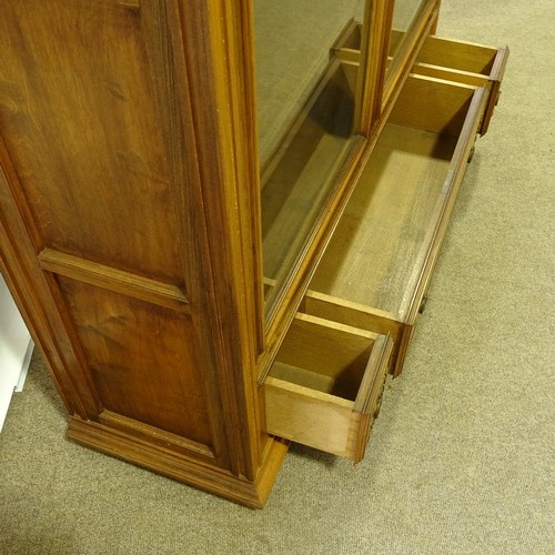 324 - A French cherrywood 2-door bookcase, circa 1920s, arch glazed panelled doors with floral carved gild... 